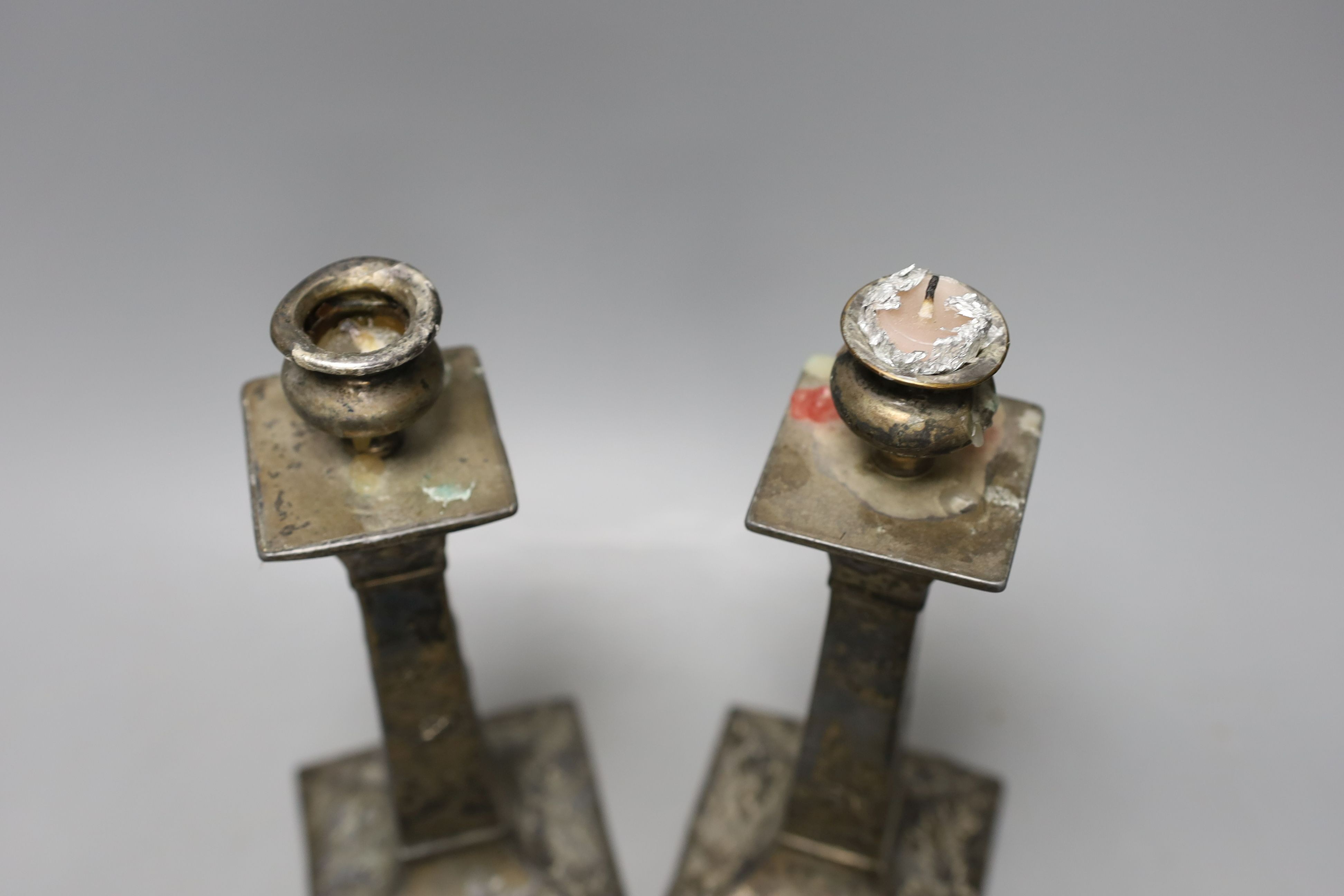 A pair of Japanese square footed embossed plated candlesticks, c.1900, 23cm tall